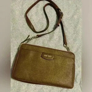 Nine West Crossbody brown with silver hardware. Snap closure and zipper pockets.